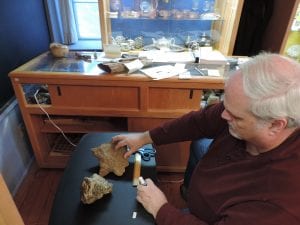 Volunteer Jack Oglesby with the geology specimens.