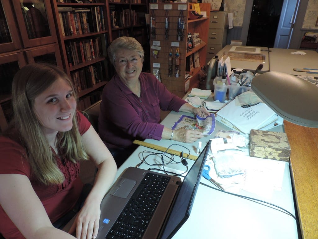 Carolyn Stauffer and Rebecca work on a women's handkerchief collection.